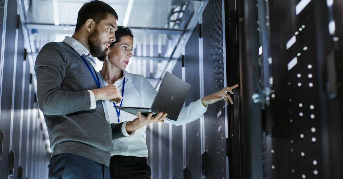 colleagues checking server with laptop